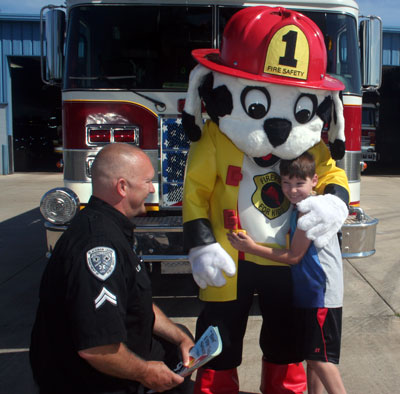 firepup mascot costume with firefighter and boy 2015